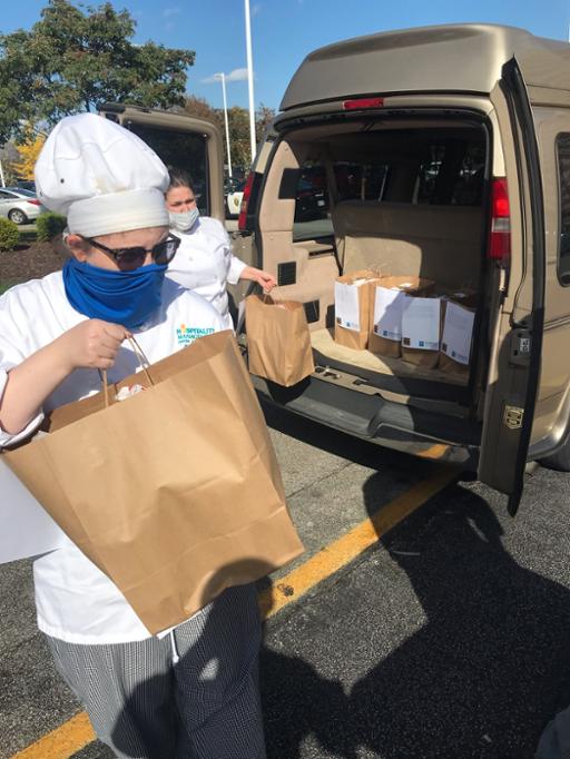 Tri-C students unloading food from a van for delivery at Lutheran Hospital