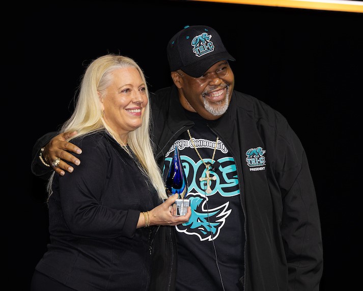 Tri-C President Dr. Michael Baston presenting Lewis Award to Marci Rapp. 