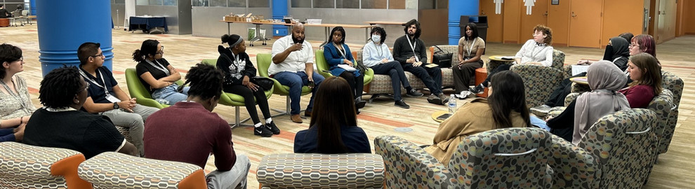 A group of students meeting with a local leader