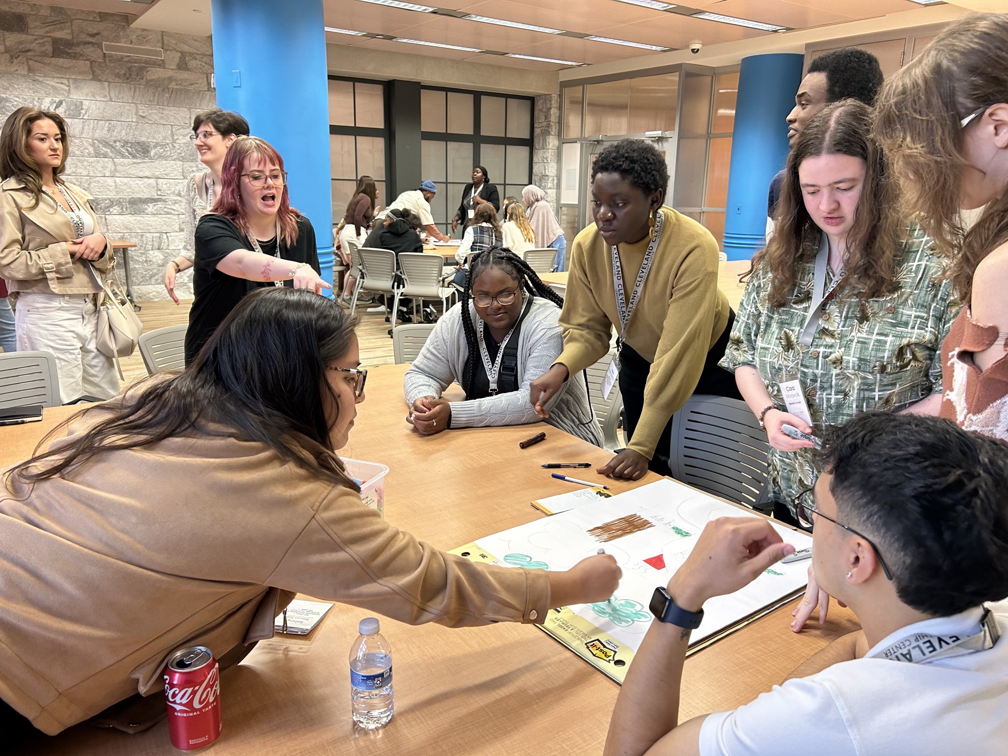 Students gathered around a table, discussing a project