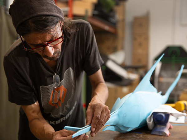 Man working on swordfish model