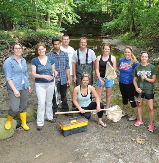 Biology students monitoring water quality in Euclid Creek with Professors Kim Ochs (far left)