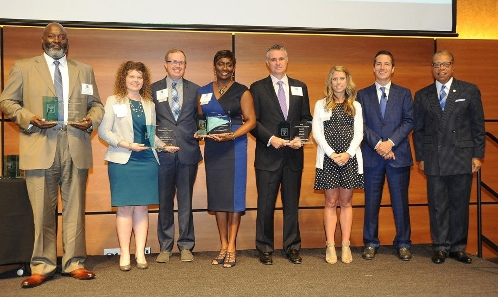 Tri-C President Alex Johnson and Guest Speaker Bernie Moreno on stage with winners.