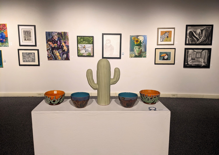artwork on gallery walls and pedestals