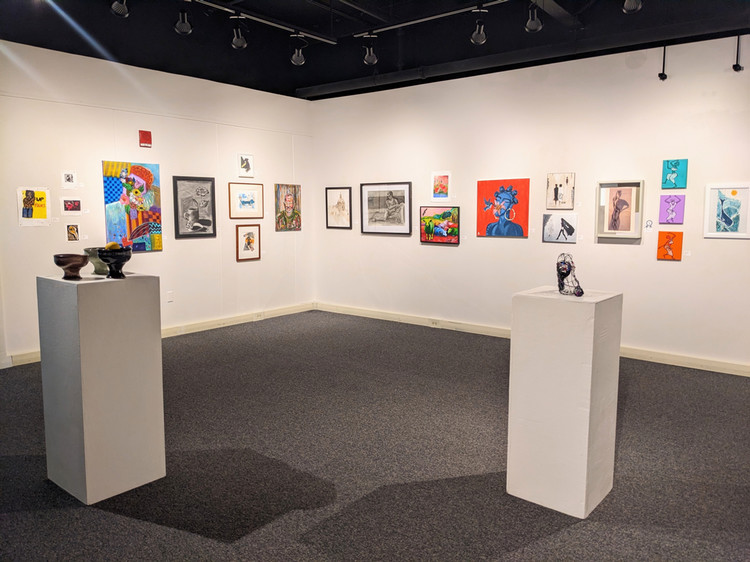artwork on gallery walls and pedestals