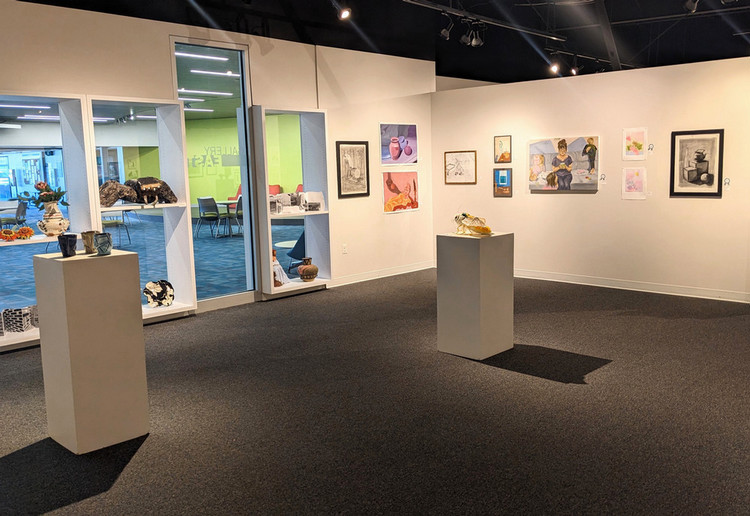 artwork on gallery walls and pedestals