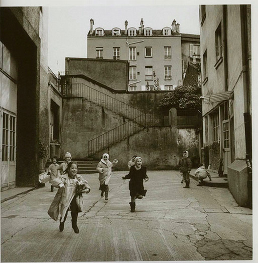 Herbert Ascherman's "Ten Children, Paris," a group of children run through a Parisian backstreet in a black and white photograph