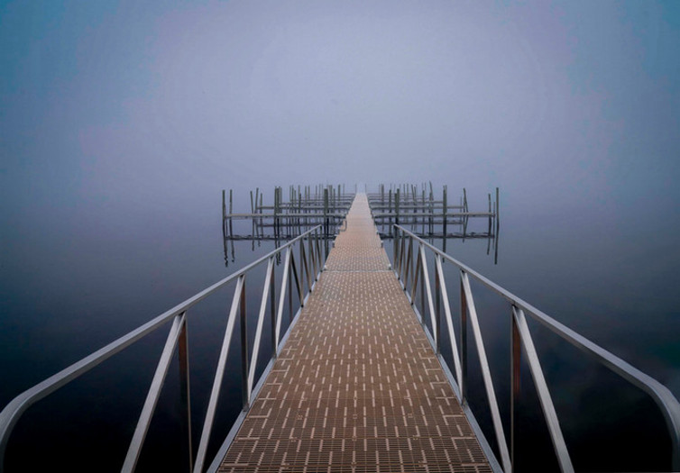 Barry Miller's "Into the Future," a photograph of a long boardwalk, surrounded by water, disappearing into a misty horizon