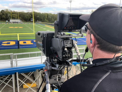 Man filming sporting event