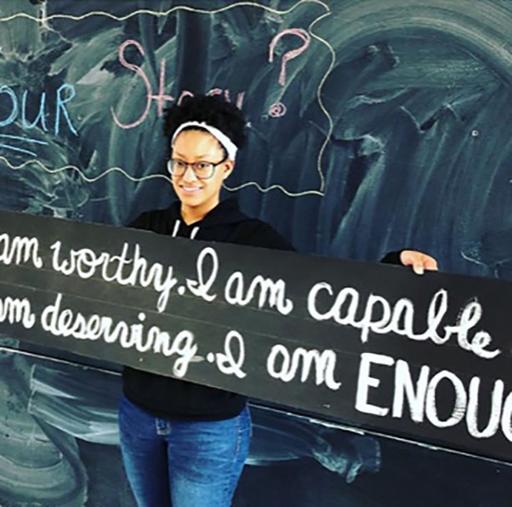 Student holding I am worthy sign