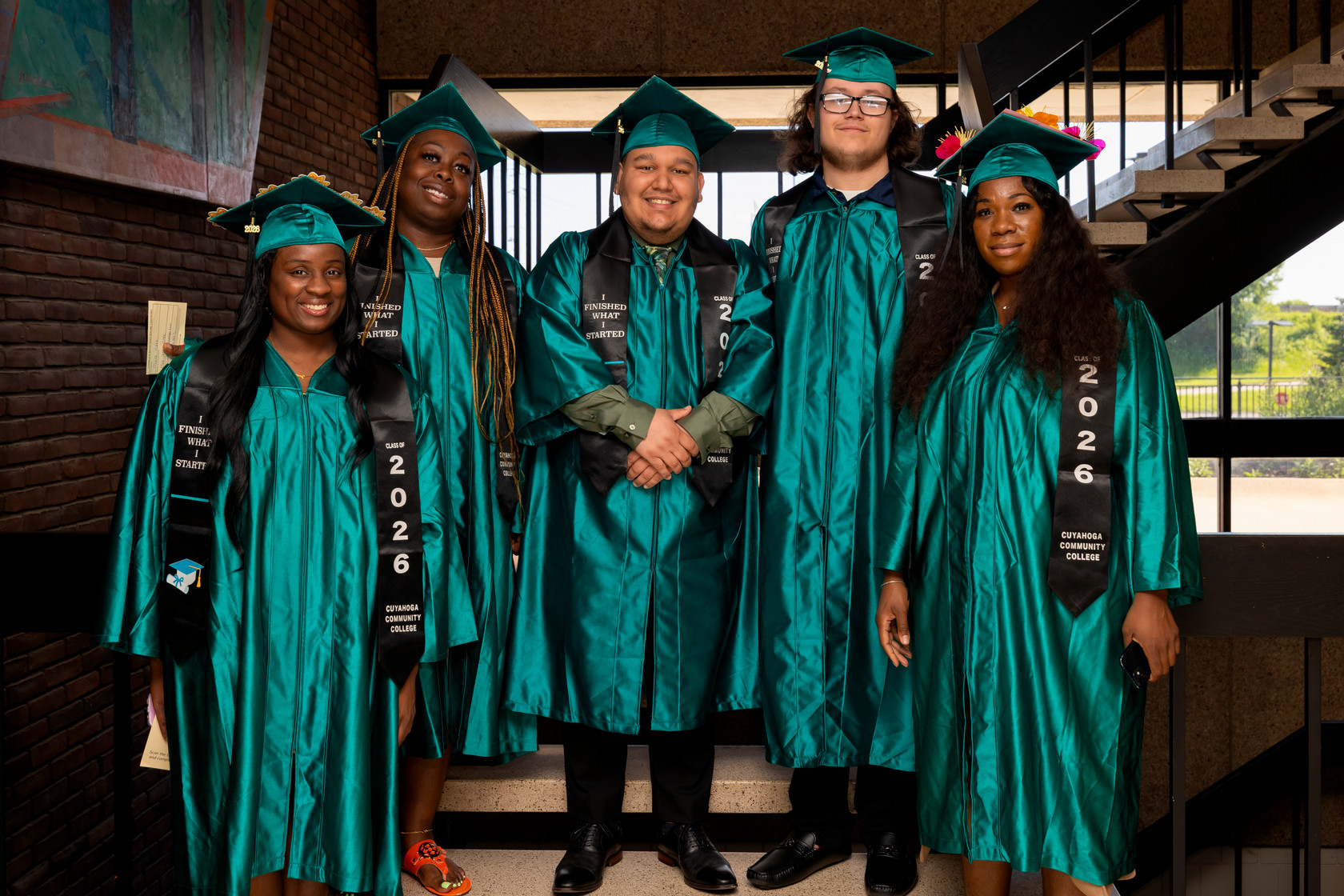 Students standing on stairs preparing for graduation