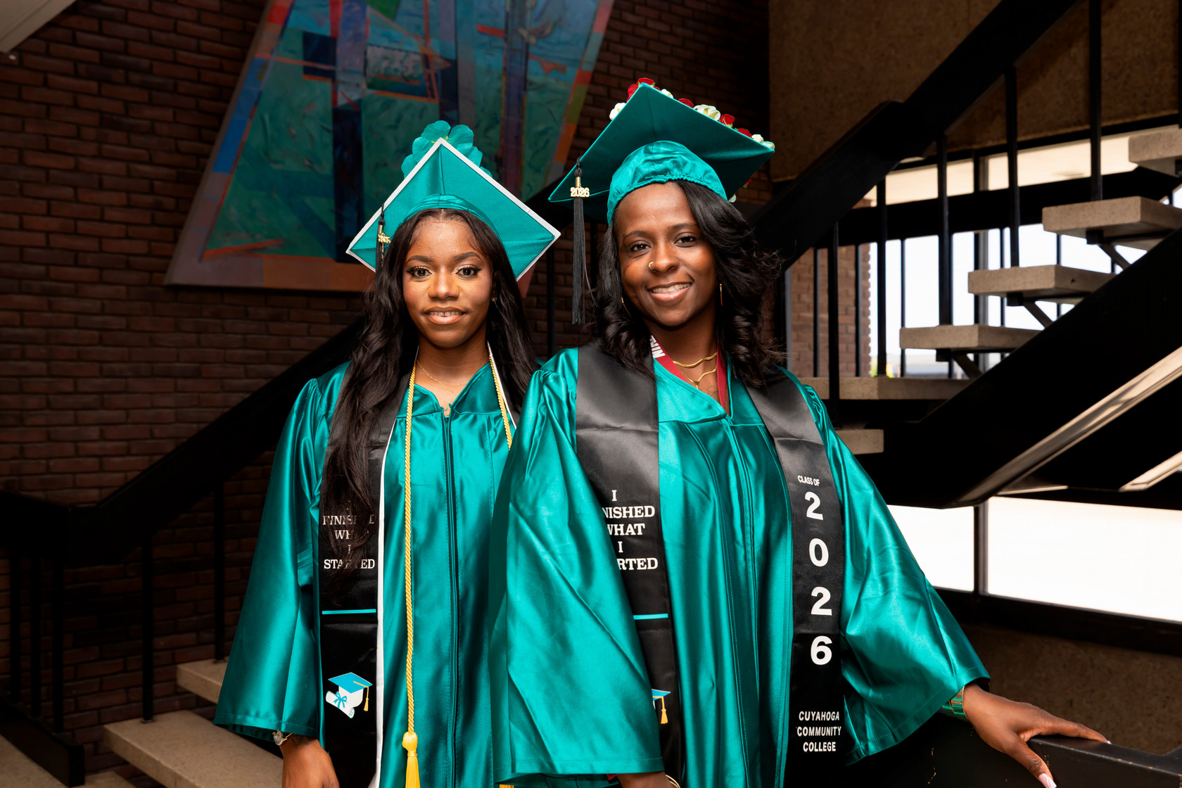 Students standing on stairs preparing for graduation