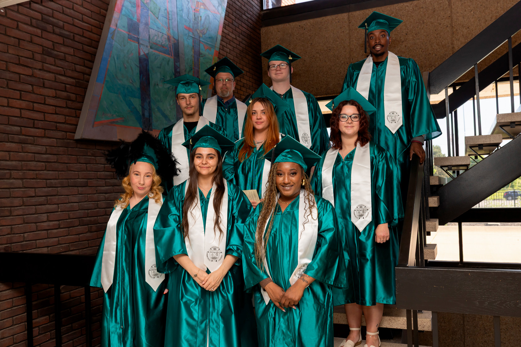 Students standing on stairs preparing for graduation
