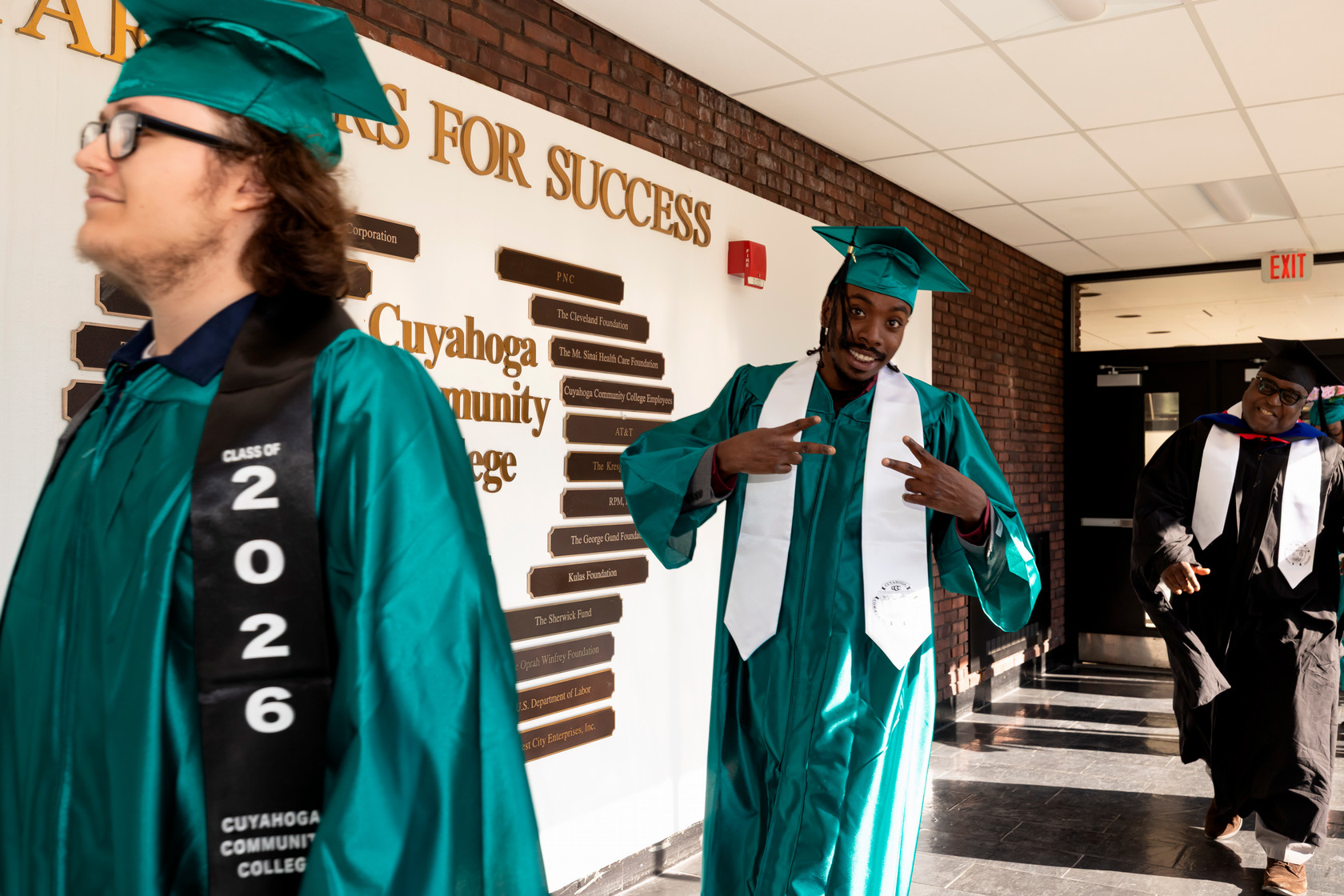 Student walking celebratory hand gesture