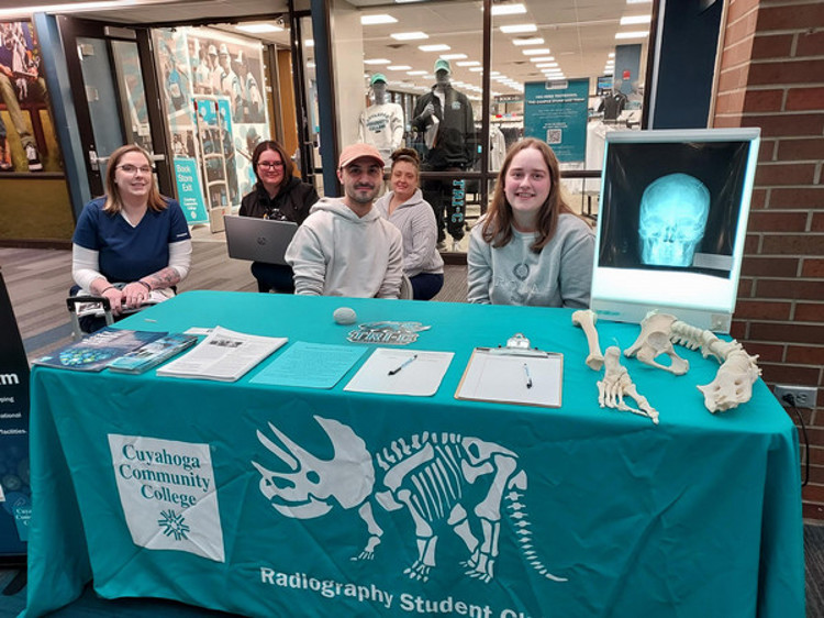 Members of the Radiology club at a table with an x-ray on display