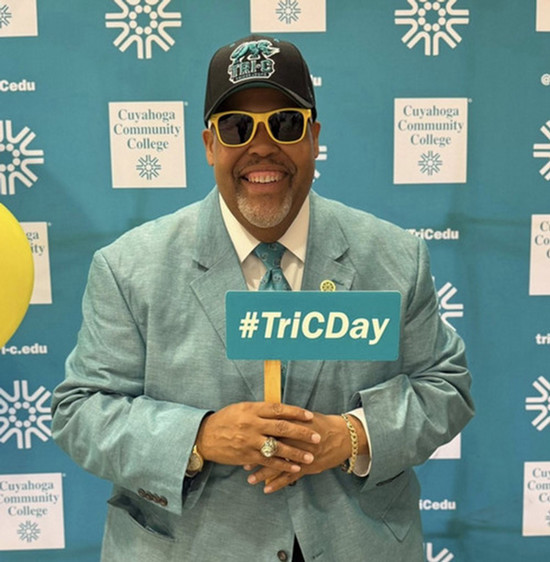 Dr. Baston with a hat, sunglasses and holding a Tri-C selfie stick