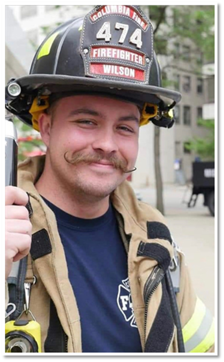 Brett Wilson in full fire kit, smiling