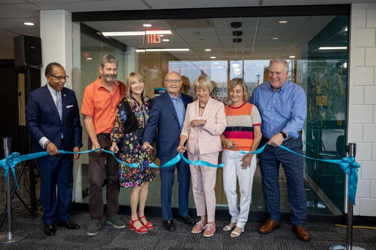 Dr Alex Johnson, Char & Chuck Fowler & their family cut ribbon in front of The Pantry at Tri-C Metro Campus