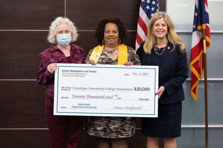 three people holding a large check