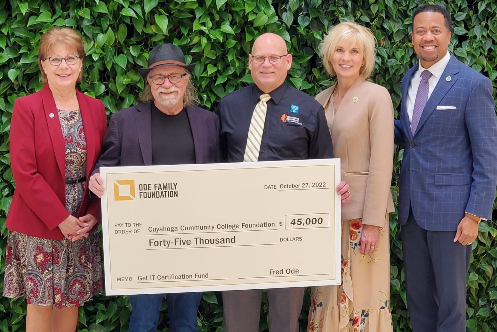 Donor Fred Ode presents a big check to Tri-C representatives
