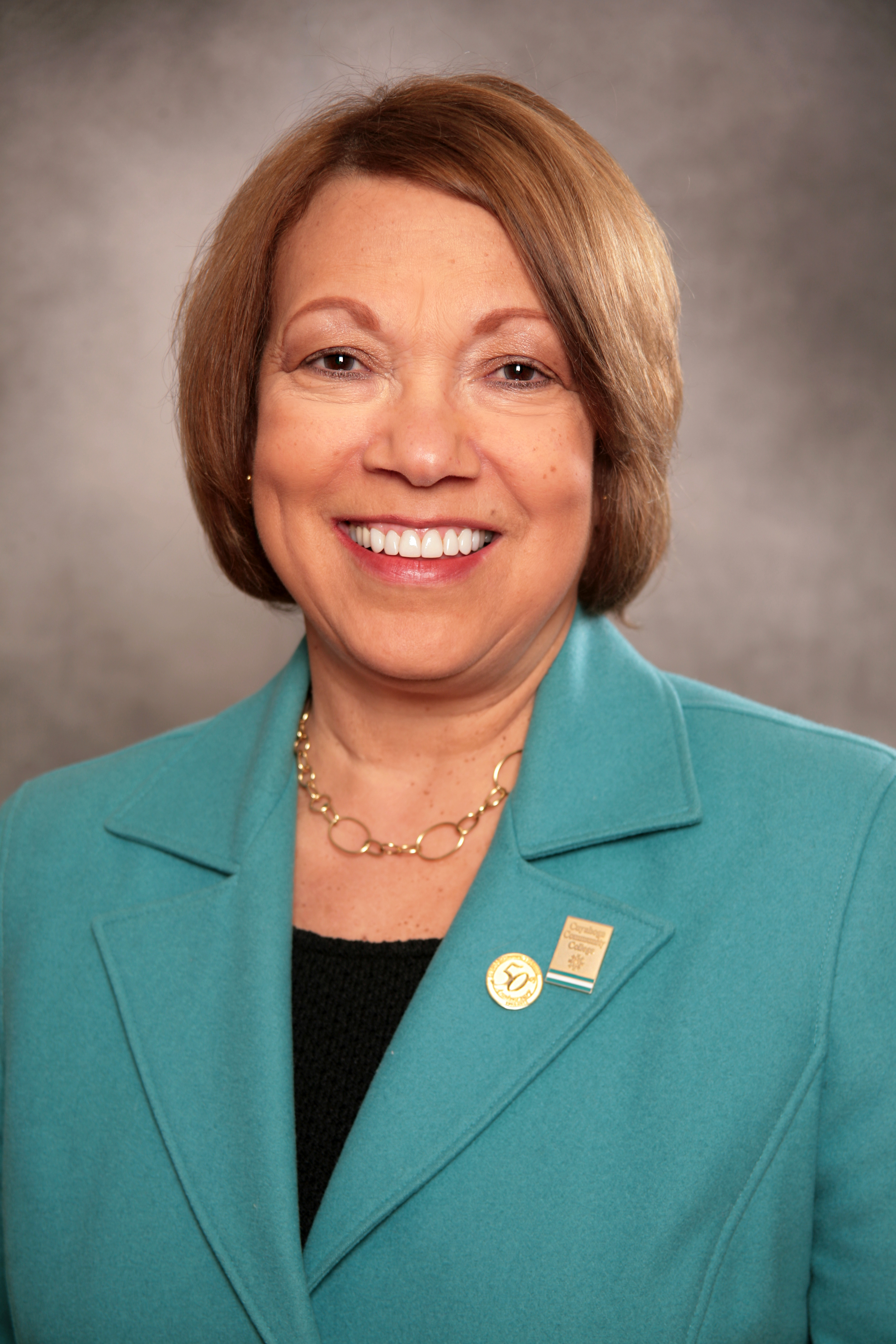 Formal portrait of Dr. Jerry Sue Thornton, in teal blazer, smiling