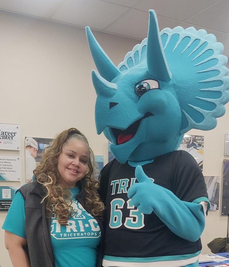 Student smiling with Stomp mascot