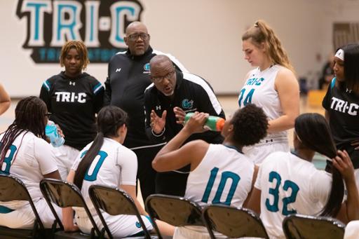 Coach Derrick Williams talking to the women's basketball team