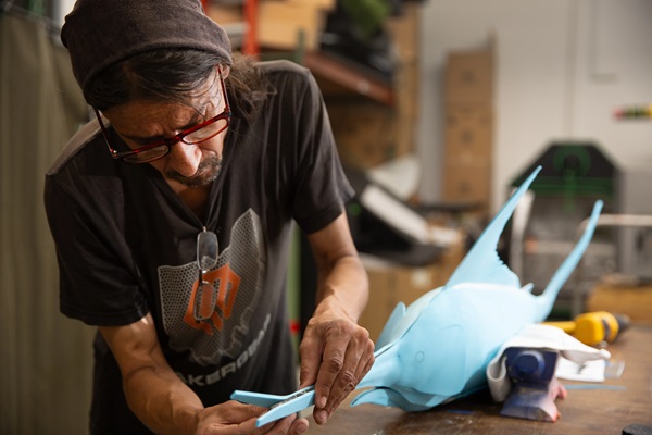 Man working on swordfish model