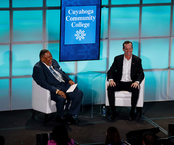 Image of Michael A. Baston and Kenny Atkinson on stage at the Presidential Scholarship Luncheon