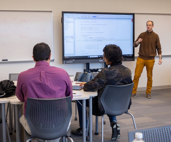 Photo of instructor and students in classroom.
