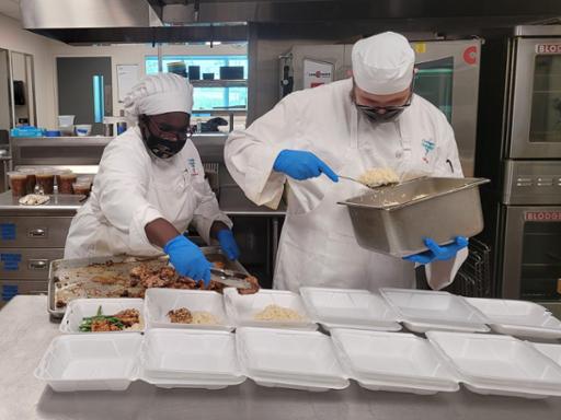 Tri-C culinary students boxing meals to send to the Back Door Ministry at St. Malachi Parish