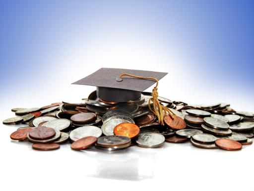 Photo illustration showing a graduation cap atop a pile of coins
