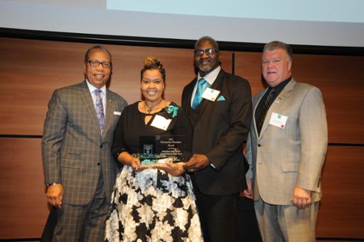 Tri-C President Alex Johnson, LaShawnda Berry-Knox, the Rev. Kenneth O. Knox and The Illuminating Company President John Skory during the Community Champion Award presentation at the College's Appreciation Breakfast, held at Corporate College East. Skory was the keynote speaker at the event.
