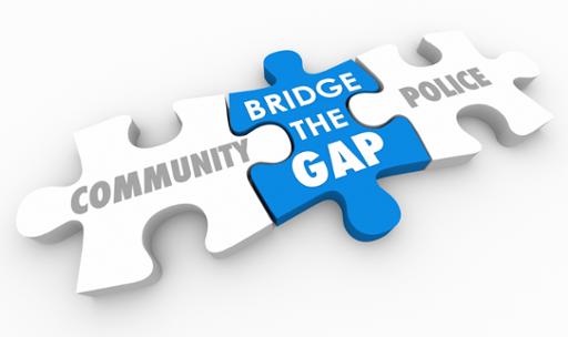 Puzzle pieces wit the words Community, Bridge the Gap and Police