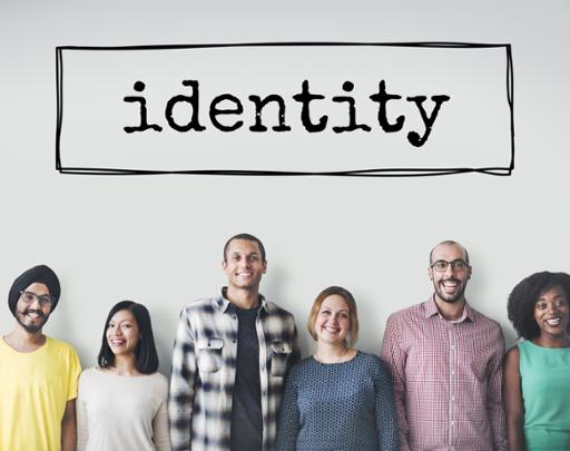 Diverse group of people standing beneath the word identity