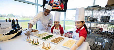 Tri-C culinary student working with children from The First Tee of Cleveland program