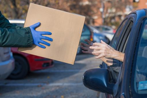 Food box being handed into a car