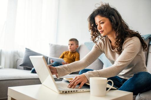 Woman working from home with child in background