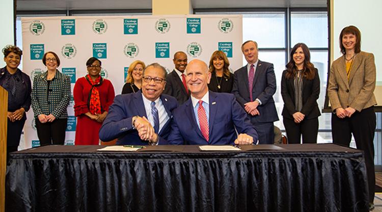 Tri-C President Alex Johnson (left) and Cleveland State President Harlan Sands shake hands after signing the Degree Link agreement on Feb. 28.