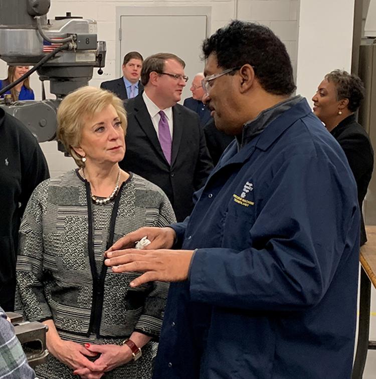 Linda McMahon talks with Tri-C instructor Fitz Arjune during her Thursday visit to the Manufacturing Technology Center.