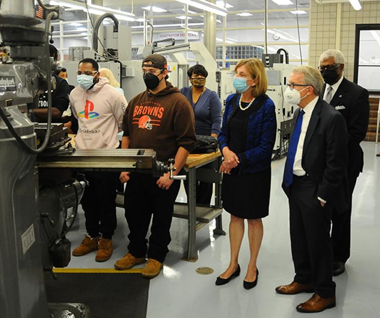 Ohio Gov. Mike DeWine (right foreground) watches students train on machinery at the MTC.