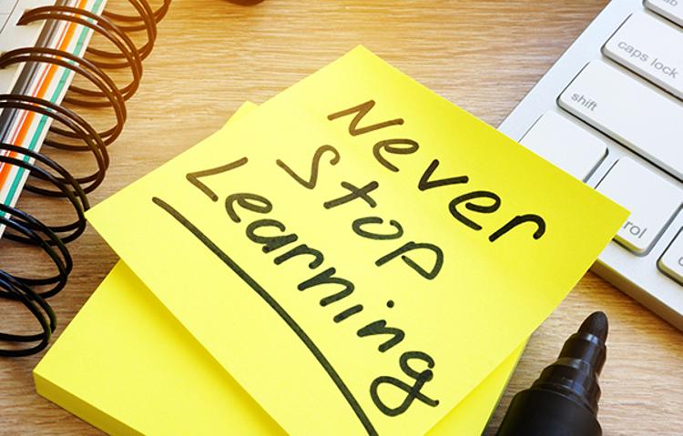 Notepad with "Never stop learning" written on it