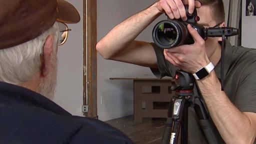 Tri-C grad Nick Hoeller photographing a veteran