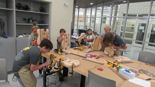 Summer campers building guitars