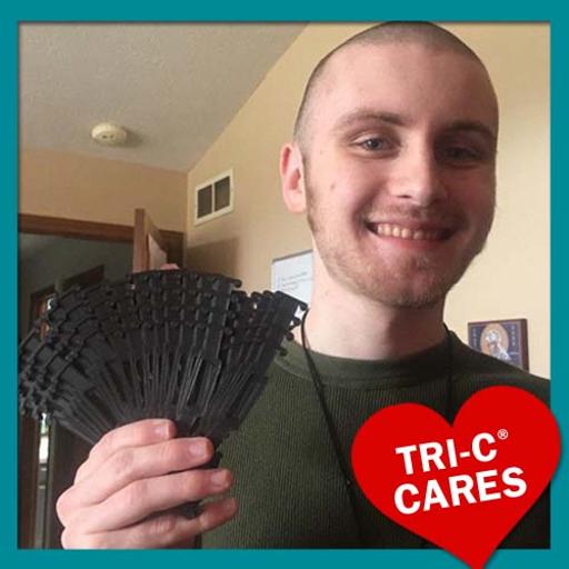 Paul Blazek holding "ear guards" made with his 3D printer