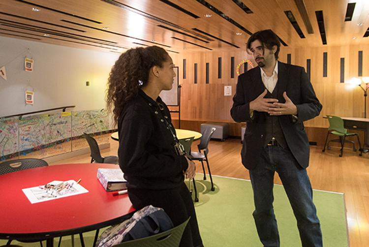Brian Hall, Tri-C associate English professor and Studio 101 director, speaks to a student.