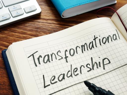Notepad with the words 'Transformational Leadership'