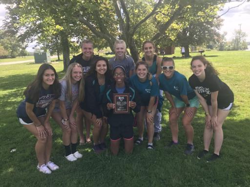 Tri-C cross country team holding the championship plaque from the Daniel Walker Invitational
