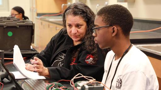 Lisa Suarez, a Youth Technology Academy instructor at Tri-C, working with a student at Cleveland's Nathan Hale School.