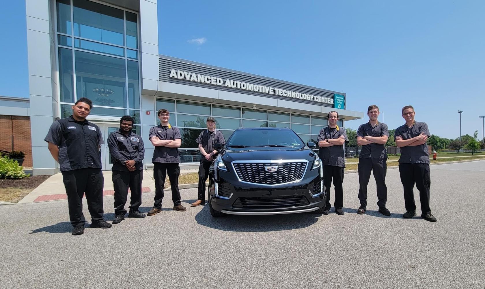 ASEP students with a 2023 Cadillac XT5 donated by GM